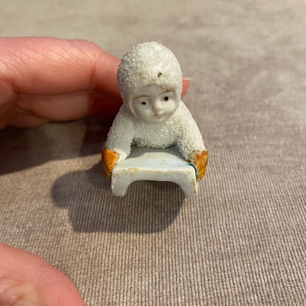 vintage snowbaby on sled